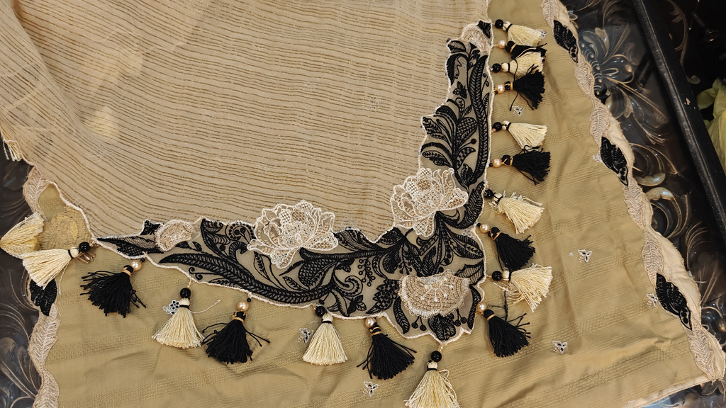 Beige zari dupatta with black and off white floral corner embroidery patch and handmade black and cream tassels with pearls by Hashtag Happiness Faisalabad