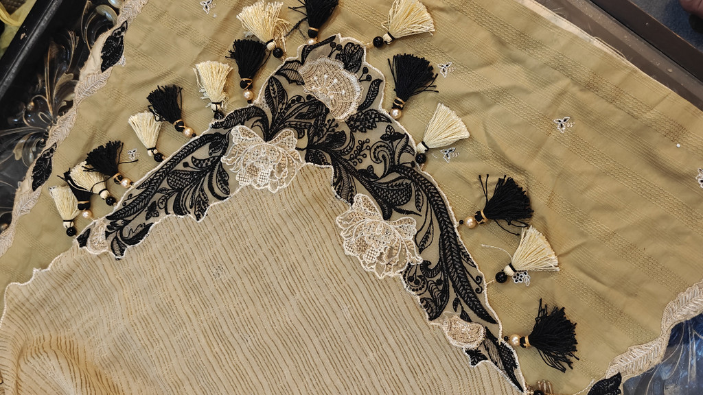 Closeup view of designer corner patch work on beige dupatta with handmade pearl tassels