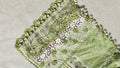  Close up of luxury green chiffon daman with handmade pearl teardrop tassels, blue and white potli buttons and green crochet lace by Hashtag Happiness tailor