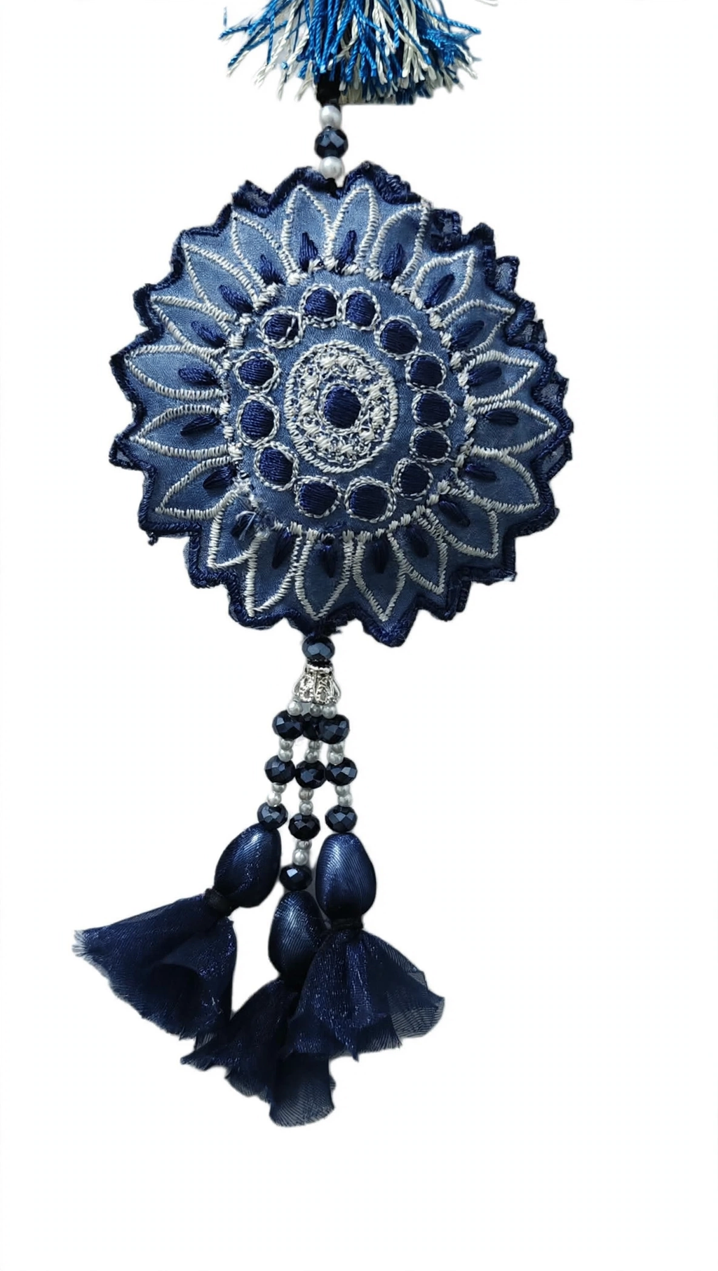 Close-up of navy blue embroidered sunflower medallion with white thread crystal beads and organza tassels handmade by Hashtag Happiness embroidery unit