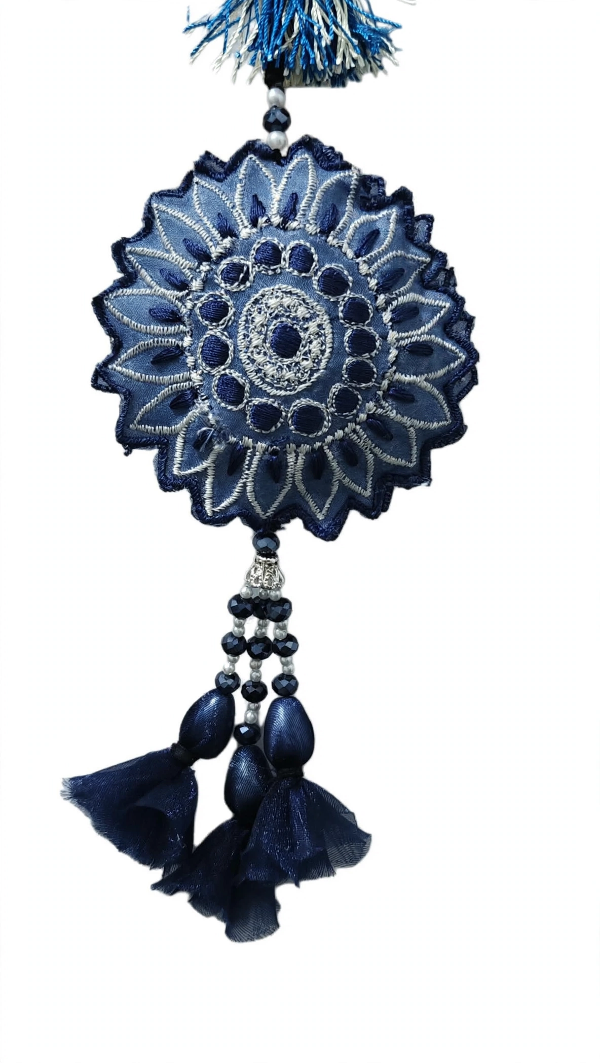 Close-up of navy blue embroidered sunflower medallion with white thread crystal beads and organza tassels handmade by Hashtag Happiness embroidery unit