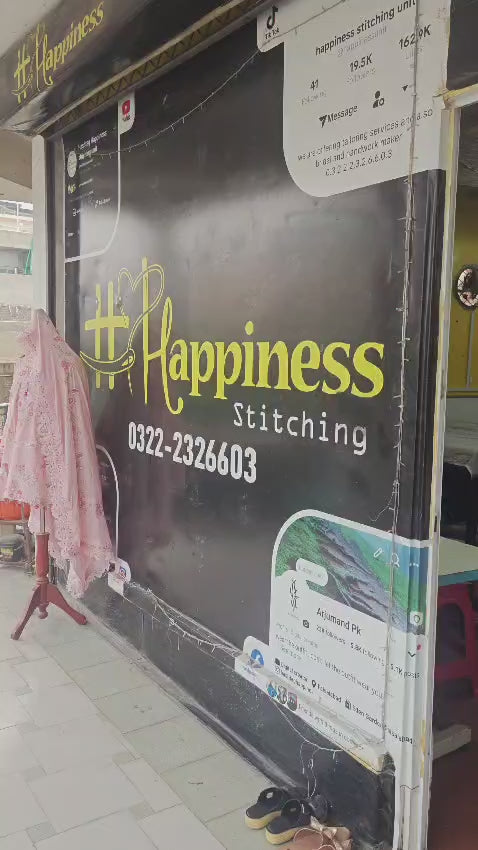 Hashtag Happiness stitching office storefront n Faisalabad showing logo, contact number 0322-2326603 and display