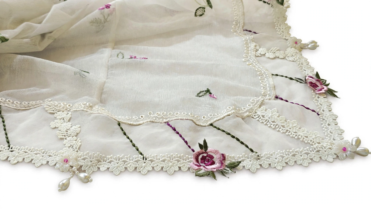 Close-up of organza dupatta border with milky lace pink embroidered rose and pearl latkan tassels handmade by Hashtag Happine