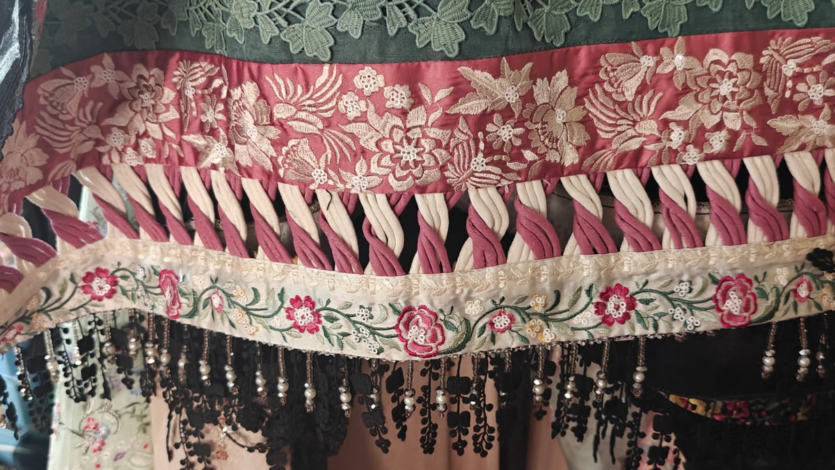 Customized daman design with handmade long twisted dori loop in cream and dusty pink velvet between red and off-white embroidered floral borders with black pearl tassels - Suffuse brand same as model made by Hashtag Happiness expert karigar Faisalabad